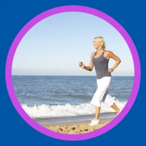An older woman jogs on the beach.