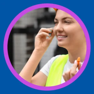 A woman puts hearing protection on. 