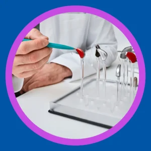An audiologist points to a device on a display of hearing aids. 