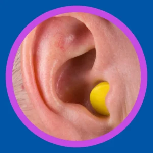 An ear has an ear plug in it. 