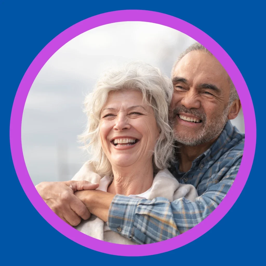 An older couple smiles together.