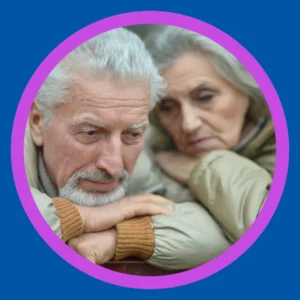 An older couple looks sad. 
