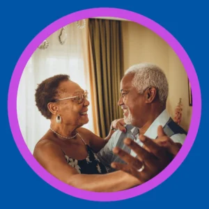 An older couple dances together happily. 