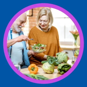 A couple makes a salad together. 