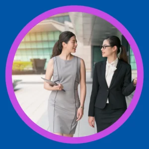 Two women walk and talk. 