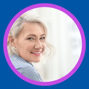 A woman wearing a hearing aid smiles happily.