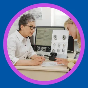 A woman talks to her audiologist.