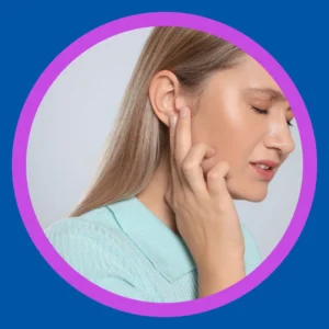 A woman holds her ear unhappily. 