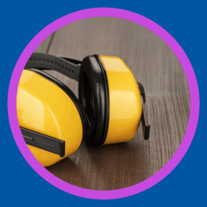 Protective headphones sit on a table. 