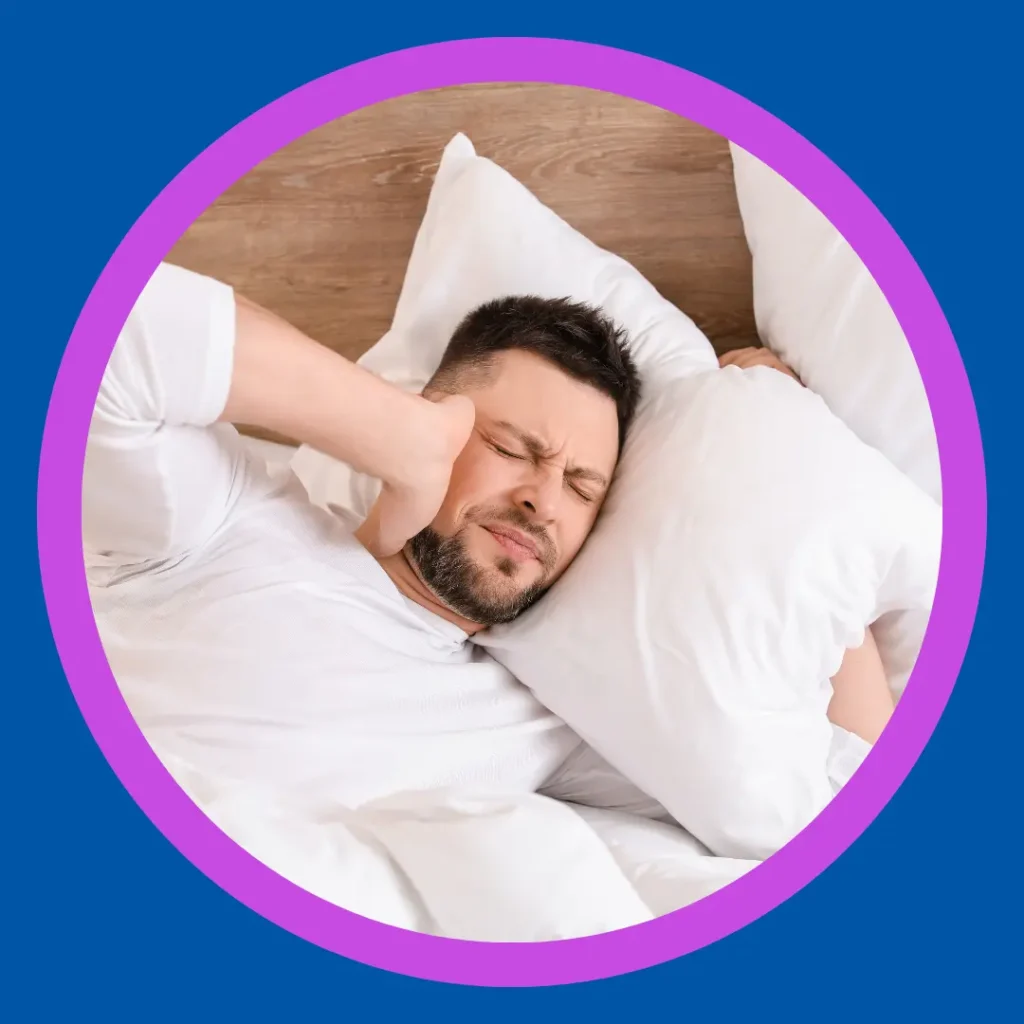 A man tries to sleep while having tinnitus.