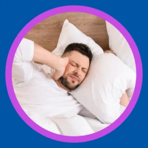 A man tries to sleep while having tinnitus.