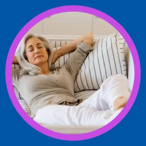 A woman relaxes comfortably on a couch. 