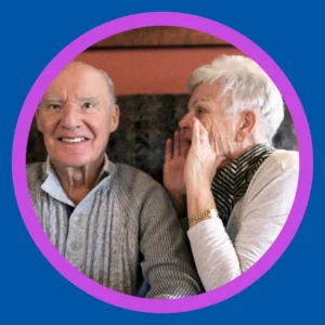 A woman yells into a man's ear. 