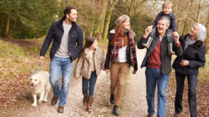 A happy extended family taking a walk in fall