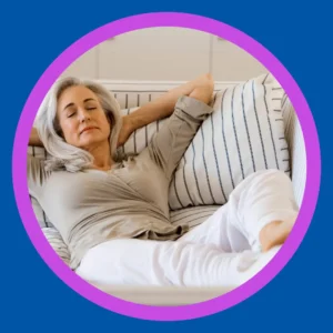 A woman naps on a couch. 