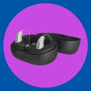 Phonak hearing aids sit in their charging case. 